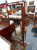 A 19TH.C.MAHOGANY CHEVAL MIRROR ON RING TURNED STAND WITH SABRE LEGS AND BRASS CASTORS.