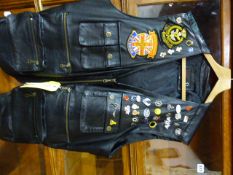 A LEATHER "BIKERS" WAISTCOAT JACKET WITH NUMEROUS BADGES