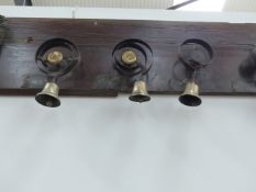 A RARE COMPLETE SET OF NINE SERVANT'S BELL ON ORIGINAL BACKBOARD MOUNT WITH ROOM NUMBERS.