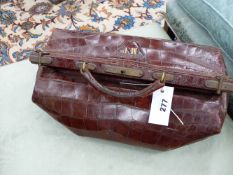 AN ANTIQUE CROCODILE SKIN GLADSTONE BAG.