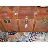 A LARGE WOOD BOUND LEATHER TRAVELLING TRUNK.