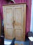 A LARGE EARLY 20TH.C.PINE TWO DOOR SHELVED CUPBOARD.