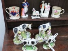 A COLLECTION OF VICTORIAN STAFFORDSHIRE POTTERY TO INCLUDE A PAIR OF COW CREAMERS, A PAIR OF