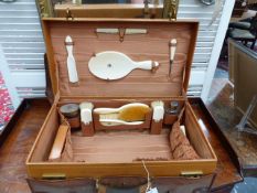 A VINTAGE DREW & SON LEATHER DRESSING CASE FITTED WITH SILVER GILT TOPPED CUT CRYSTAL BOTTLES, IVORY