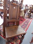 AN 18TH.C.OAK SIDE CHAIR WITH INSET PANEL BACK, PLANK SEAT OVER STRETCHER BASE.