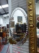 A PAIR OF OVAL MIRROR BACK REFLECTOR WALL LIGHTS WITH SINGLE ORMOLU CANDLE ARMS. 40CM HIGH