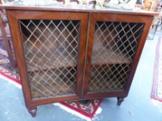 A REGENCY MAHOGANY CONCAVE FRONT SMALL BOOKCASE WITH LATTICE PANEL DOORS.