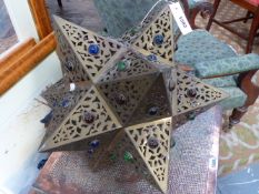 A PIERCED BRASS STAR FORM EASTERN STYLE HANGING LIGHT WITH MULTI COLOURED GLASS INSETS. 40 X 40CM