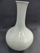 AN ORIENTAL PALE CELADON GLAZE BOTTLE FORM VASE, POSSIBLY KOREAN. 28CM HIGH