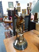 A BRONZED FIGURE OF A BLACKSMITH CONFORMING BLACK MARBLE CIRCULAR BASE. OVERALL HEIGHT 62CM