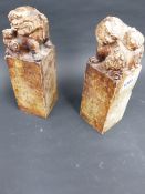 A PAIR OF CHINESE CARVED SOAPSTONE SEALS, FOO LION TOPS EXTENSIVELY INSCRIBED. H.24cms