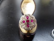 AN 18CT GOLD AND PLATINUM DIAMOND AND RUBY CLUSTER RING