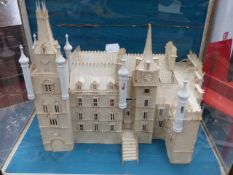 A VINTAGE MODEL OF A GOTHIC CHATEAU IN A GLAZED CASE WITH CARVED FRAME. H.59cms.