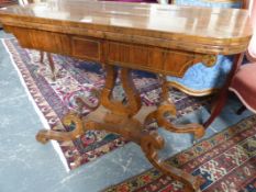 A REGENCY ROSEWOOD AND BRASS INLAID FOLD OVER CARD TABLE ON LYRE SUPPORT AND QUADRUPED S-SCROLL