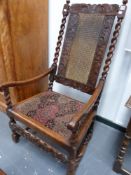 AN ANTIQUE AND LATER CARVED WALNUT CANE BACK ARMCHAIR WITH BARLEY TWIST SUPPORTS AND STRETCHERS.