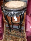 A CHINESE CARVED HARDWOOD TALL STAND/TABLE WITH INSET SHAPED MARBLE TOP AND PIERCED APRON.