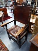 A PAIR OF CARVED CONTINENTAL LEATHER SEAT AND BACK HALL ARMCHAIRS.