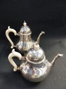 A SILVER MATCHING TEAPOT AND COFFEE POT WITH IVORY HANDLES AND FINIALS. LONDON 1943/4 BY GARRARD &