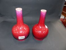 A PAIR OF CHINESE SANG DE BOEUF BOTTLE FORM VASES. 18CM HIGH