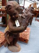 A CAST IRON GARDEN FIGURE/ FOUNTAIN IN THE FORM OF A PUTTO HOLDING A FISH. H.79cms.