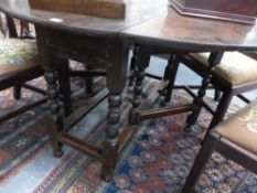 AN ANTIQUE AND LATER OAK GATELEG DINING TABLE WITH TURNED SUPPORTS AND PLAIN STRETCHERS. W.