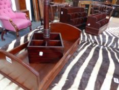 AN ANTIQUE MAHOGANY BOOK TROUGH TOGETHER WITH TWO MAHOGANY STATIONERY RACKS AND FOUR BOTTLE WINE
