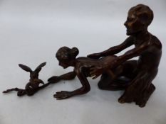 A CONTINENTAL EROTIC BRONZE TWO PART GROUP OF A SATYR AND A MAIDEN HOLDING A BRANCH WITH TWO