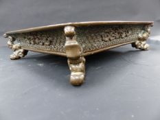 AN ORIENTAL BRONZE FOOTED SQUARE DISH WITH FLOWERHEAD DECORATION AND WRITHING DRAGON AND CHARACTER