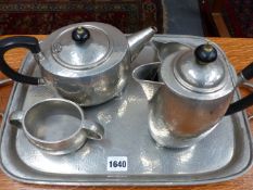 A FIVE PIECE PLANISHED PEWTER TUDRIC TEA SET OF OVAL FORM TEA AND COFFEE POTS, SUGAR BOWL AND