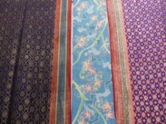 TWO INDONESIAN SILK SARI CLOTHS WITH GOLD THREAD DECORATION AND A BATIK LONG FLORAL DECORATED