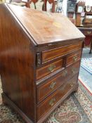 A GEO.III. AND LATER MAHOGANY AND INLAID SMALL BUREAU WITH FITTED INTERIOR OVER TWO SHORT AND TWO