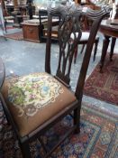 A SET OF FOUR GEO.III.MAHOGANY DINING CHAIRS WITH CARVED AND SHAPED CREST RAILS.