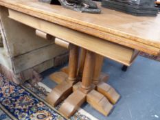 A PAIR OF 20TH.C.ARTS AND CRAFTS STYLE WALNUT CENTRE TABLES ON CLUSTERED COLUMN SUPPORTS.