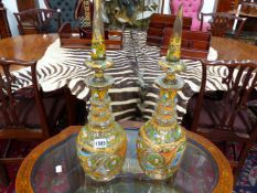 A PAIR OF LARGE CUT GLASS DECANTERS MADE AND DECORATED FOR THE PERSIAN MARKET WITH OVER ALL FLORAL