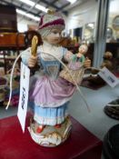 A MEISSEN PORCELAIN FIGURE OF A YOUNG GIRL HOLDING A DOLL. H.14cms.