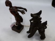 A CONTINENTAL BRONZE FIGURE OF A PLAYFUL SATYR WITH IMPRESSED MARKS TO BASE. H.7cms AND AN EASTERN