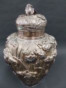 A LARGE JAPANESE ART NOUVEAU SILVER COVERED CADDY OF OVOID FORM. OVERALL RELIEF DECORATION OF IRIS