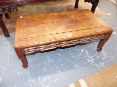 A CHINESE CARVED HARDWOOD LOW TABLE WITH PIERCED APRON. 75CM LONG