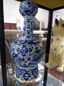 A DELFT BLUE AND WHITE GOURD SHAPED TALL VASE DECORATED WITH BIRDS AND FLOWERS. H.38cms.