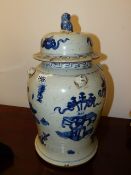 A PAIR OF CHINESE BLUE AND WHITE COVERED BALUSTER VASES WITH FOO LION FINIALS AND APPLIED MASKS TO