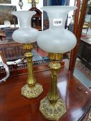 A PAIR OF VICTORIAN GILT BRASS "PALMER AND CO, LONDON" CANDLE LAMPS WITH FROSTED GLASS FLARED FORM