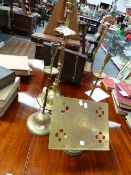 A NEAR PAIR OF EASTERN BRASS CANDLESTICKS WITH SLENDER TURNED SHAFTS, DRIP PANS AND DOME FORM BASES,