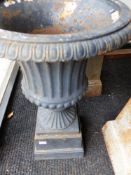 A PAIR OF ANTIQUE STYLE CAST IRON CAMPAGNA FORM GARDEN URNS ON SQUARE PLINTH BASES. H.68cms.