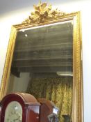 A LARGE ANTIQUE FRENCH GILT FRAMED OVERMANTLE MIRROR WITH ELABORATE PEDIMENT OF BIRDS, FOLIAGE AND