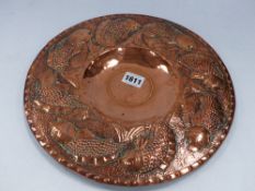 A COPPER ARTS AND CRAFTS CIRCULAR PLAQUE WITH FISH DECORATED BROAD RIM ATTRIBUTED TO JOHN PEARSON,