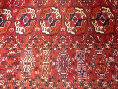 AN ANTIQUE TEKKE BOKHARA MAIN CARPET. 290 X 265CM