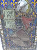 AN ANTIQUE STAINED GLASS PANEL DEDICATED TO GEOFFREY CHAUCER, DECORATED WITH ARMORIAL CREST