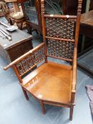 AN UNUSUAL ENGLISH AESTHETIC MOORISH REVIVAL WALNUT LOW ARMCHAIR, POSSIBLY RETAILED BY LIBERTY'S,