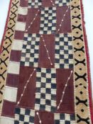 AN UNUSUAL WEST AFRICAN, POSSIBLY GOLD COAST TRIBAL PATCHWORK LONG PANEL WITH COWRIE SHELL