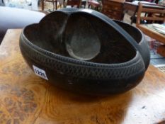 A COCO DE MER SERVING DISH WITH PIERCED HANDLE.